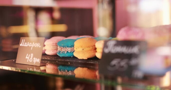 Sweet colorful macaroons on showcase in a cafe