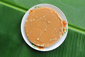 Coconut palm sugar in a cup Place with banana leaves for making desserts