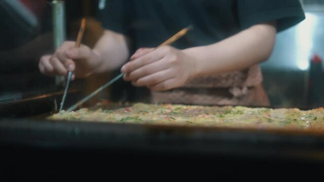 Chef Preparing Takoyaki at a Street Food Stall