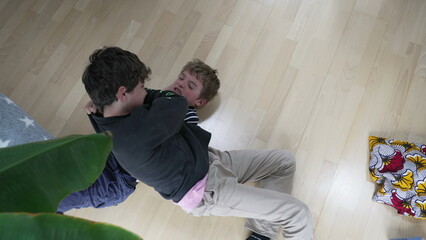 Family Feud - Brothers Engaged in Heated Floor Wrestling. Sibling Showdown of Brothers Wrestling...
