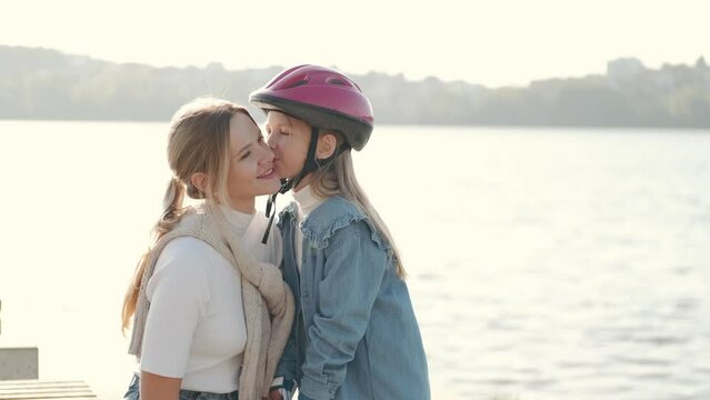 Mon helping her daughter in the park rollerblading enjoying there time togeather