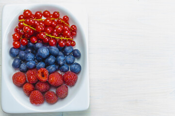Fresh and vibrant berries adorn the left-aligned vertical container in a culinary delight