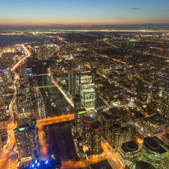 The view of downtown Toronto skyline skyscrapers from the top of CN tower. Lake at dawn, city light bright night long exposure aerial above view