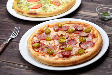 tasty pizza on the wooden background