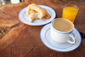 Selective Focus on Coffee with Croissants and Orange Juice. With a Wooden Background. With Copy Space