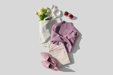 Fashion spring outfit. Purple  jumper with bouquet of tulips flowers in bag,  jeans and loafers....
