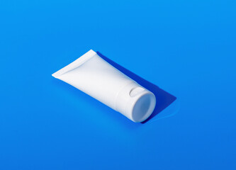 Cream tube mock up, small cosmetic mini package mockup on blue