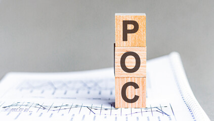 text poc - Proof of Concept - acronym concept on cubes and diagrams on a gray background, business...
