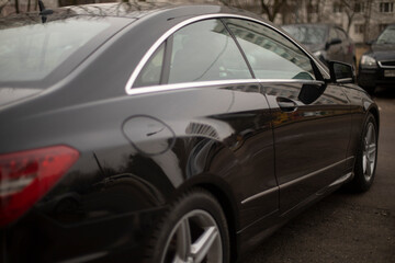 Car is in parking lot. Car in city. Details of transport on street.