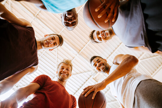 Low angle portrait young basketball players looking at camera