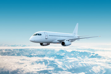 White modern airplane fly over snow covered mountain ranges