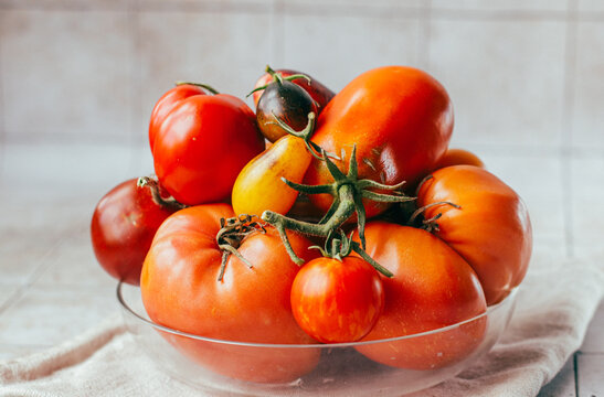 organic ripe colorful tomatoes in a glass bowl on the table
