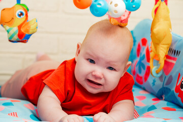 Portrait of cute baby a newborn girl playing in the room