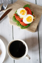 Healthy breakfast with egg, tomatoes and salad. on a wooden table. food