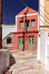 Fototapeta na wymiar Colorful traditional multi-colored houses on a narrow street of Symi island.