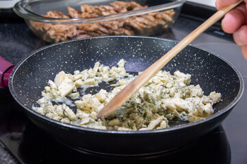 Flavor Fusion: Melting the Blue Cheese for the Perfect Sauce.