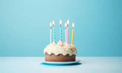 birthday cake with  six 6 candles on pastel blue background with copyspace