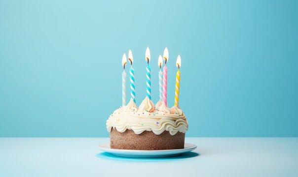 birthday cake with  six 6 candles on pastel blue background with copyspace