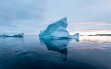 Arctic nature landscape with icebergs in Antarctica with midnight sun sunset sunrise in the...