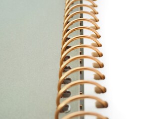 Open gold spiral notepad with a grey cover closeup