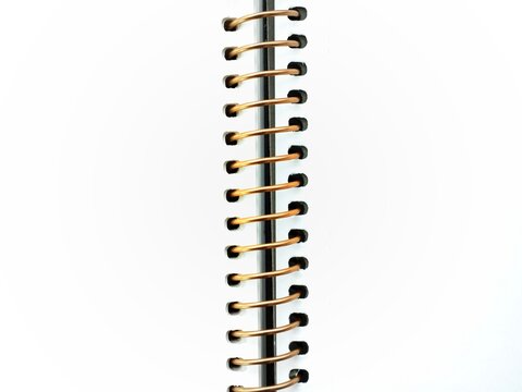 Open gold spiral notebook with blank pages and copy space
