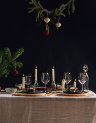 winter holidays, dinner party and celebration concept - scandinavian christmas table serving with burning candles at home over black background