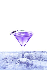 Modern transparent cocktail adorned with lavender standing on ice bar. Isolated white background.