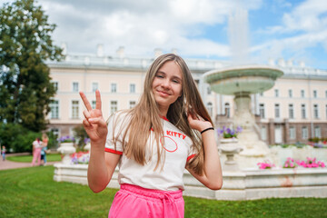 Cute teenage girl in the Catherine Park in St. Petersburg, tourist season in Tsarskoye Selo, Pushkin