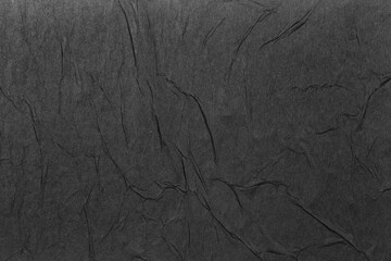 Abstract background of black paper with folds.