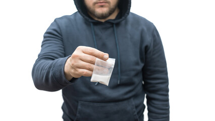 Criminal man in a hood holds transparent plastic bag with white powder hard drugs isolated on white...