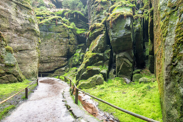 Remains of rock city in Teplice Rocks, part of Adrspach-Teplice landscape park in Broumov highlands region of Bohemia, Czech Republic
Tourist pathway between rock towers and walls. Europe.