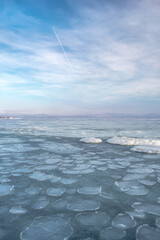 Sea winter landscape. Sea slush and ice floes on the sea surface in winter during sunset. Fabulous...