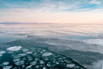 Sea winter landscape. Sea slush and ice floes on the sea surface in winter during sunset. Fabulous...