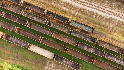Empty railway wagons for the transport of grain, shot by a drone from above.