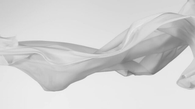 Super Slow Motion of Waving Transparent Cloth. Filmed on High Speed Cinema Camera Phantom VEO 4K, 1000 fps. Isolated on White Background.