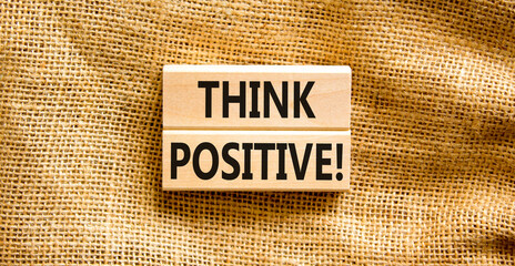 Think positive symbol. Concept words Think positive on beautiful wooden block. Beautiful canvas...