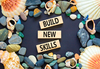 Build new skills symbol. Concept word Build new skills on beautiful wooden block. Sea shell stone....