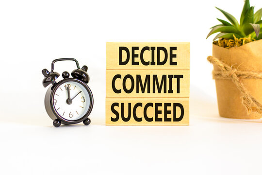Decide commit succeed symbol. Concept word Decide Commit Succeed on beautiful wooden block. Black alarm clock. Beautiful white table background. Business decide commit succeed concept. Copy space.
