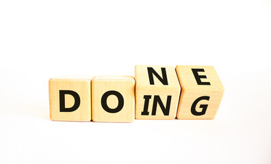 Doing and done symbol. Concept words Doing Done on wooden block. Beautiful white table white background. Business doing and done concept. Copy space. © Dzmitry