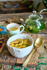 Oatmeal with caramelized apple. wooden background, side view