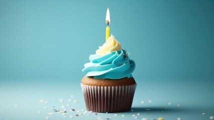 Birthday cupcake with a candle on a light blue background 