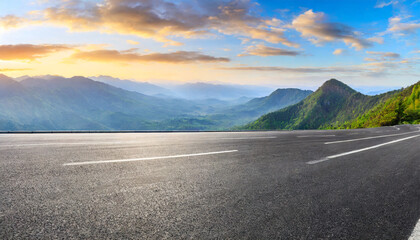 asphalt road and mountain range natural landscape at sunrise panoramic view