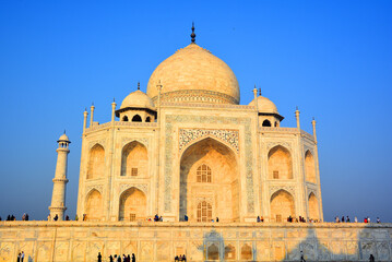 Fototapeta na wymiar View of the Taj Mahal at sunrise is an ivory-white marble mausoleum on the right bank of the river Yamuna in Agra 