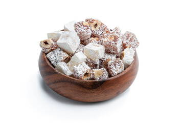 Turkish delight with phistachio and almond covered with coconut in wooden bowl isolated on white