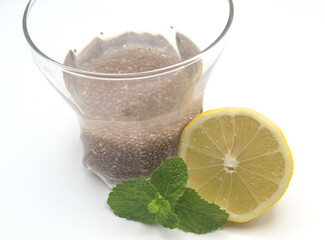 Chia water with lemon and mint, in a glass.