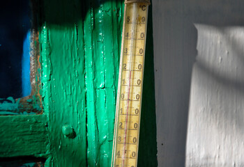 old wooden window. old street thermometer on an old window in sunlight