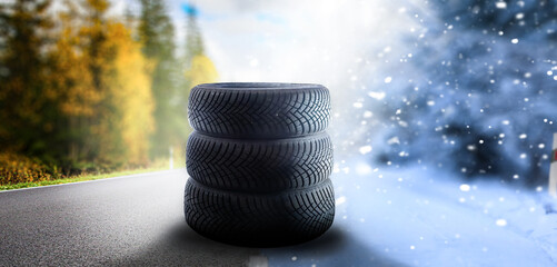 Swap winter tires for summer tires - time for summer tires. Winter tires on a asphalt road. Four...