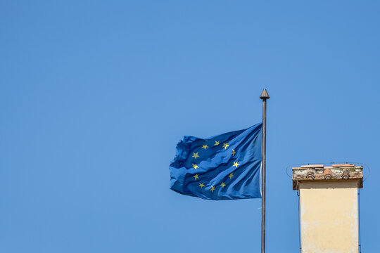 EU flag and chimney with blue sky background and copy space