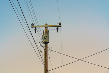 Power electric pole line against  sky at sunset