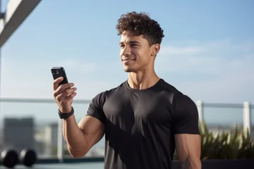 Tuinposter A young fitness blogger or personal trainer effectively guides online exercise sessions using a smartphone. © Regina